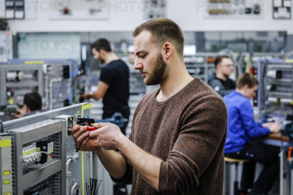 Remscheid, North Rhine-Westphalia, Germany - Trainees in electrical professions, an industrial electrician assembles a circuit, Vocational Training Centre of the Remscheid metal and electrical industry. - FOR EDITORIAL USE ONLY!