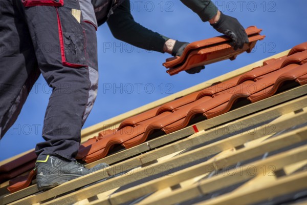 Roofer covering a tiled roof