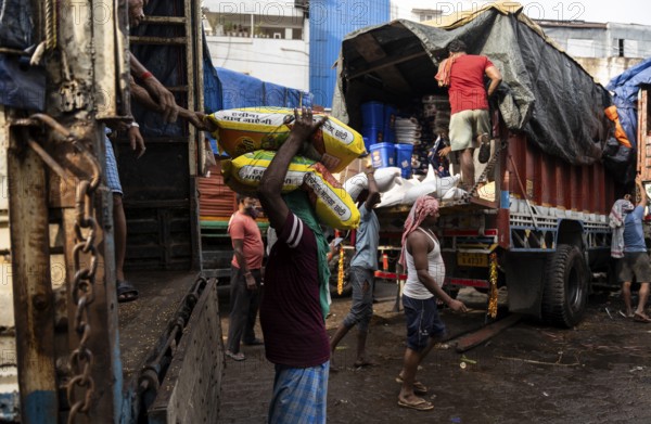 GUWAHATI, INDIA - MAY 1: Labourers carries goods in a wholesale market, in Guwahati, India, on May 1, 2025. May Day or Workers Day is a global holiday celebrated on May 1st to honor workers and their contributions, Asia