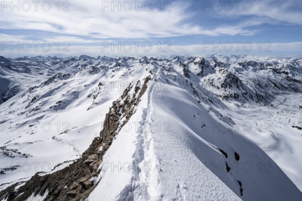 Tracks in the snow on a narrow mountain ridge in winter, summit of Piz Grialetsch, view of mountain panorama with snow, Grisons Haute Route, Albula Alps, Rhaetian Alps, Grisons, Switzerland, Europe