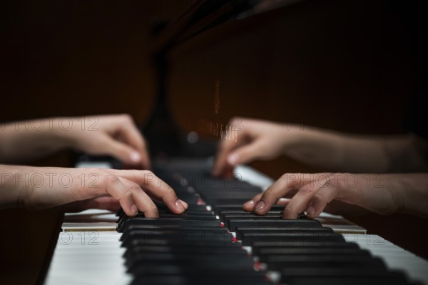 Hands of a young pianist playing on the keyboard of a Steinway & Sons grand piano, Stuttgart, Baden-Württemberg