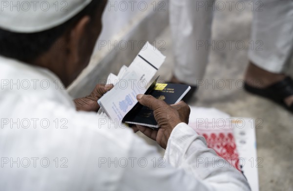 Hajj pilgrims check passport and documents before leaving to the airport, in Guwahati, India on 3 May 2025