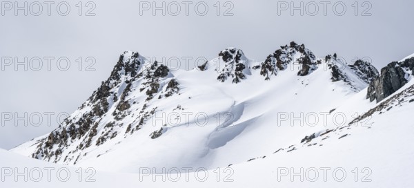 Minimalist winter landscape, white snow and dark mountains on the Scalettahorn, Graubünden, Switzerland, Europe