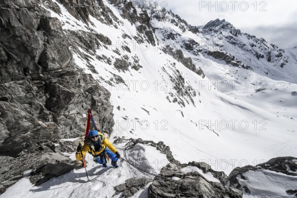 Climbers with skis ascending a steep snow slope to the Porta d'Es-cha saddle, Bündner Haute Route ski tour, Albula Alps, Rhaetian Alps, Grisons, Eastern Switzerland, Switzerland, Europe