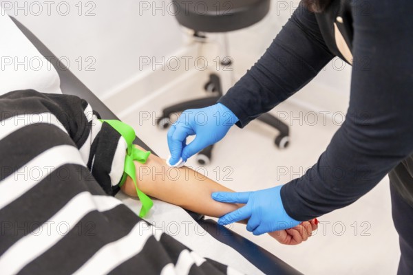 Woman lying on stretcher ready for blood extraction in a baldness treatment clinic