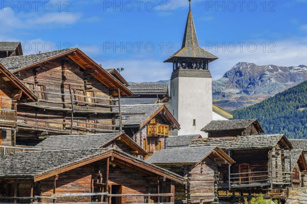 Old wooden houses and the Saint Theodule church in the historic village centre, Grimentz, Val d'Anniviers, Valais Alps, Canton Valais, Switzerland, Europe