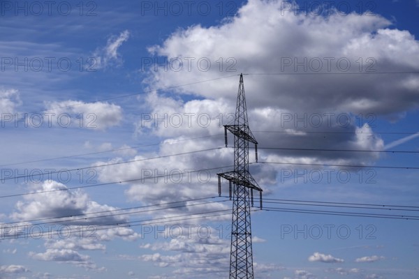 High-voltage pylon in front of a cloudy sky, symbolic image of infrastructure, Germany, Europe