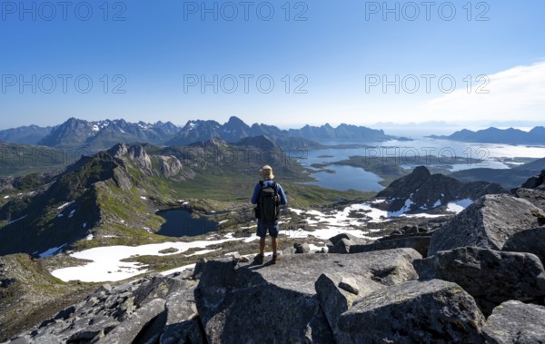 View of mountains and fjord landscape, mountain panorama, mountaineer at the summit of Rundfjellet, lake Hellskarvatnet, Svolvaer, Nordland, Norway, Europe