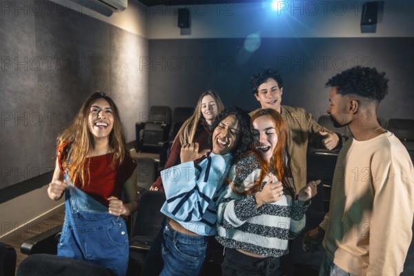 Group of friends enjoying a disco dance event at the cinema, laughing and having fun together