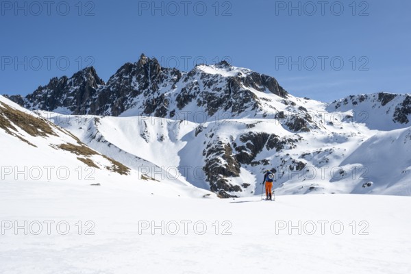 Ski tourers on the Graubünden Haute Route in the Val Susauna mountain valley, snow-covered mountains, winter in the Albula Alps, Graubünden, Switzerland, Europe