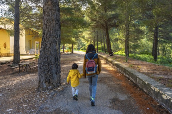 Mother and son enjoying a peaceful walk in the natural setting of the sanctuary of fontcalda in gandesa, tarragona