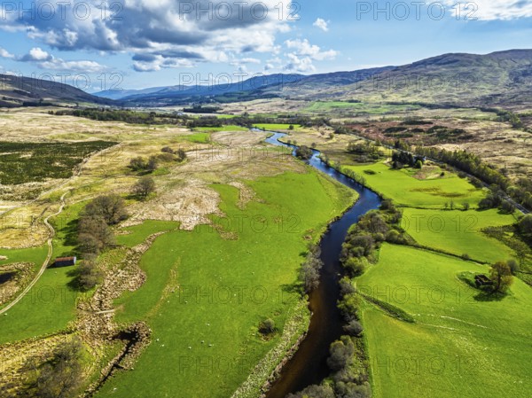 Farms and Mountains over River Dochart and Road A85 from a drone, Perthshire, Scotland, UK