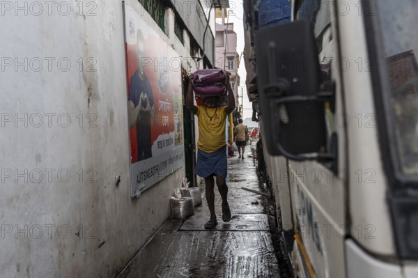 GUWAHATI, INDIA - MAY 1: Labourers carries goods in a wholesale market, in Guwahati, India, on May 1, 2025. May Day or Workers Day is a global holiday celebrated on May 1st to honor workers and their contributions, Asia