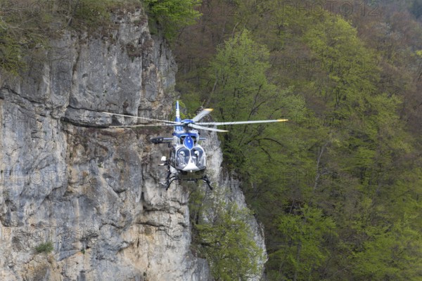 Police rescue operation. Helicopter in action at the slide rock near Bad Urach, Reutlingen district, Swabian Alb on 23/04/2025