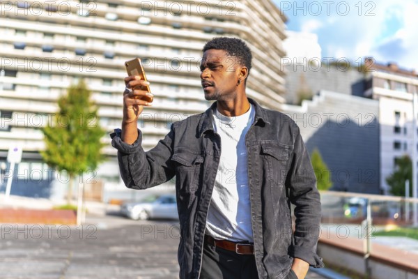 African man looking to online maps to find a direction in the city