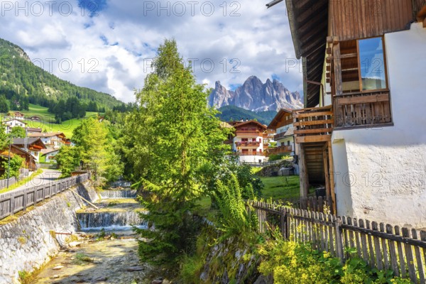 Scenic summer view of santa maddalena village with the odle mountains reflecting in the funes valley, dolomites, italy