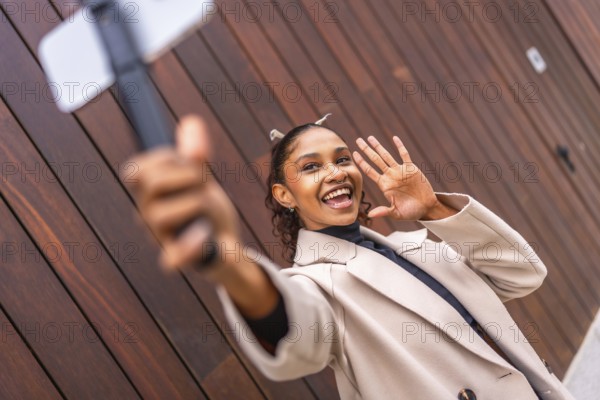 African american young female Content creator recording a new vlog using phone in the city