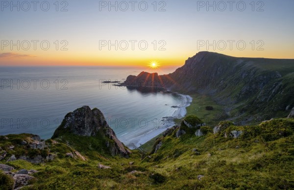 View of coastal landscape at sunset, cliffs and summit of Måtind or Måtinden, Høyvika beach and sea, Andøya island, Vesterålen, Nordland Norway
