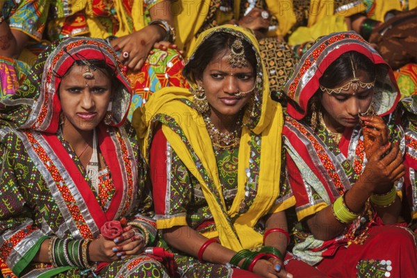 PUSHKAR, INDIA, NOVEMBER 21, 2012: Unidentified Rajasthani girls in traditional outfits prepare for dance perfomance at annual camel fair Pushkar Mela in Pushkar, Rajasthan, India, Asia