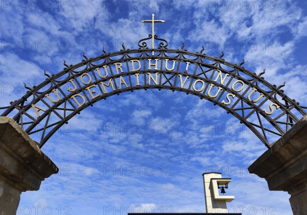 Wrought-iron portal by Francois Theis with the inscription Heute Ihr Morgen Wir, entrance to the cemetery in Consdorf, Duchy of Luxembourg