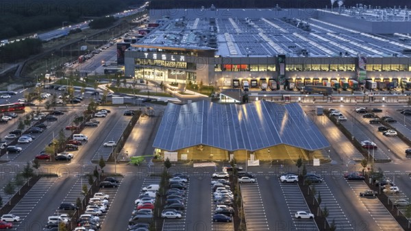 Tesla Giga Factory at the blue hour, centre, photovoltaic system above a charging station for electric vehicles, Grünheide, 25.09.2024, Grünheide, Brandenburg, Germany, Europe