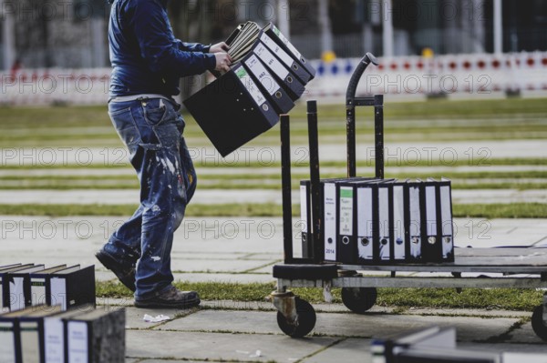 Files are cleared away after a protest action by the German Confederation of Skilled Crafts in front of the Federal Chancellery in Berlin, 26 February 2024. The German Confederation of Skilled Crafts demonstrates against the economic policy of the federal government as well as the high level of bureaucracy and the improvement of location conditions