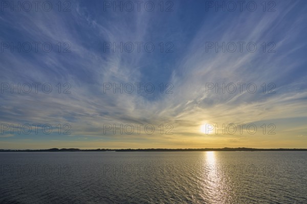 Sunrise over the calm sea, with wide sky and soft clouds in warm light, Bergen, Vestland, Norway, Europe