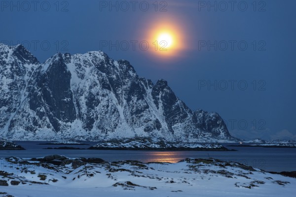 Moonrise, winter landscape, Lofoten island Vestvågøya at the fjord Gimsøystraumen, Lofoten, Northern Norway, Norway, Europe