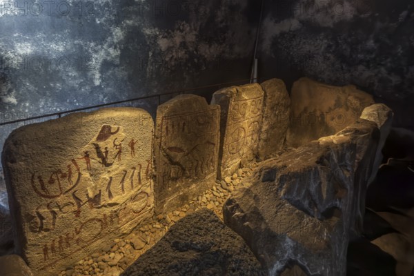 Carved figures in stone slabs inside the King's Tomb, a Bronze Age tomb in Kivik, Simrishamn Municipality, Skåne County, Sweden, Scandinavia, Europe