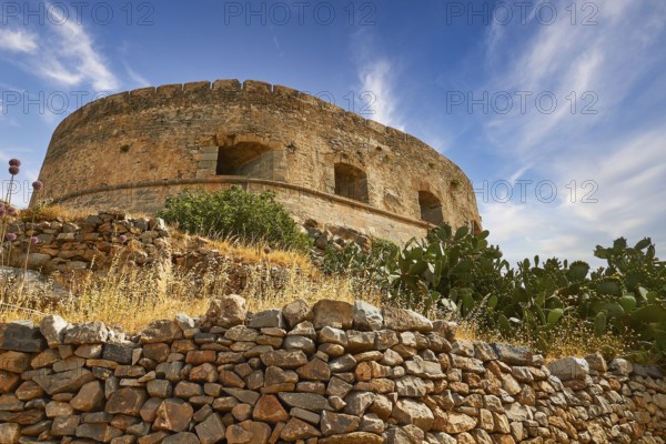An old round tower on a hill with cacti and a clear blue sky, Venetian Sea Fortress, Leper Island, Spinalonga, Elounda Bay, Mirabello Bay, East Crete, Crete, Greek Islands, Greece, Europe