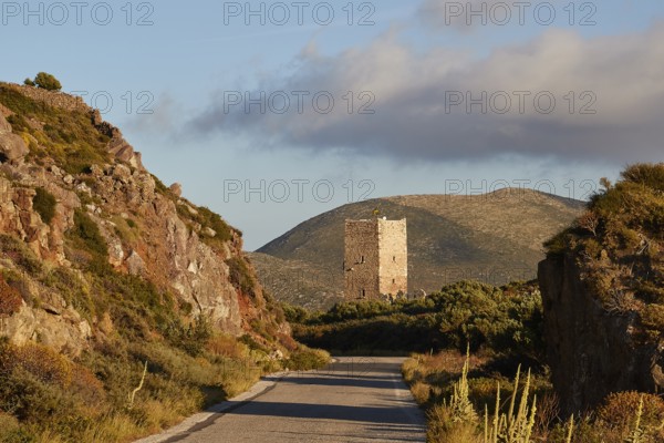 A road leads to an old tower in a mountainous landscape during the golden hour, residential tower, hotel, Mani Peninsula, Peloponnese, Greece, Europe