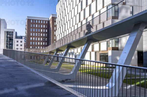 The Parkbruk, cycle and pedestrian bridge in the city centre of Antwerp, crosses a multi-lane city centre road with tram lines and thus connects two lively city districts Kop Spoor Noord and Eilandje, 140 metres of curved ramp on the western side for driving up and down, walking, Belgium, Europe