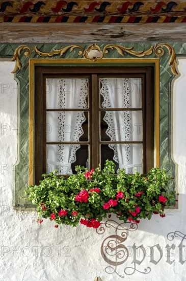 Typical Lüftlmalerei around window with geraniums, Wallgau, Werdenfelser Land, Upper Bavaria, Bavaria, Germany, Europe