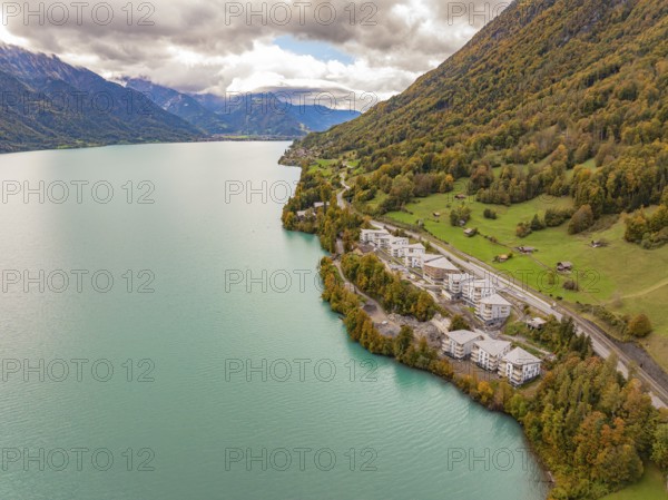 Lake with neighbouring buildings on the mountain slopes under a cloud cover, Lake Brienz. Switzerland