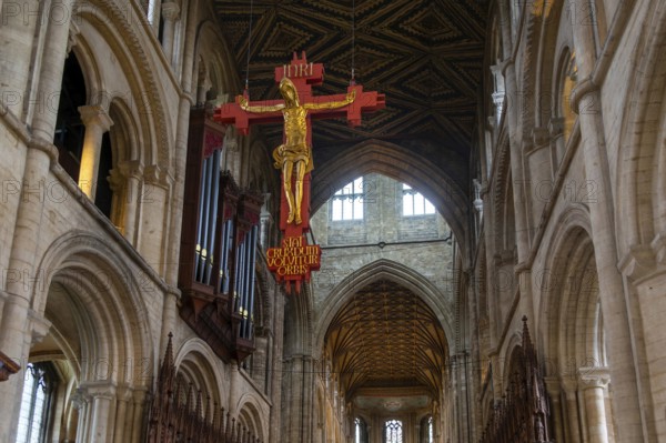 Interior of cathedral church, Peterborough, Cambridgeshire, England, UK looking up at sculpture of Jesus Christ on Cross