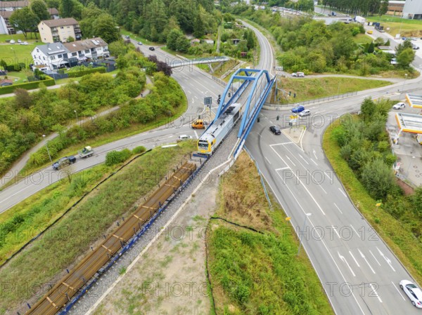 Railway line and train on a bridge over a road crossing, track construction, rail delivery for Hermann Hessebahn, Calw, Black Forest, Germany, Europe