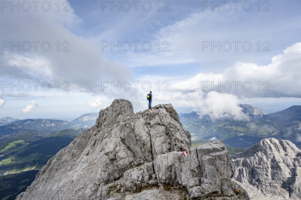Mountaineer on a narrow rocky ridge, Watzmann crossing to Watzmann Mittelspitze, view of mountain panorama, Berchtesgaden National Park, Berchtesgaden Alps, Bavaria, Germany, Europe