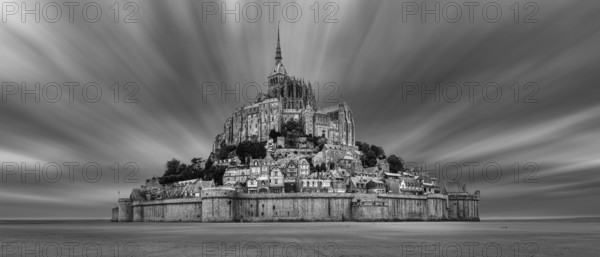 Impressive view of Mont Saint-Michel in black and white, surrounded by dramatic clouds, Le Mont-Saint-Michel