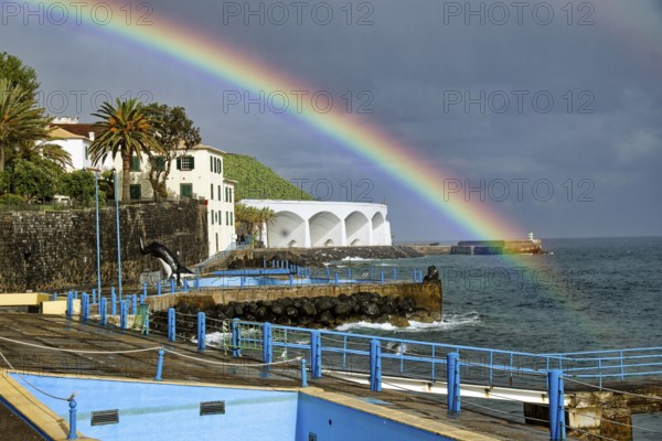 Promenade in rainy weather with rainbow on the beach of the Atlantic Ocean, municipality of Santa Cruz, Madeira, Portugal, Europe