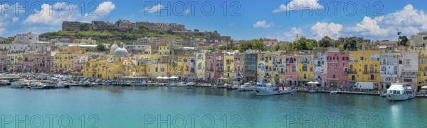 Procida Island, Campania, Italy, June 10, 2022: Italy, Procida Island shoreline with shops and colorful old city buildings facing the sea, Europe
