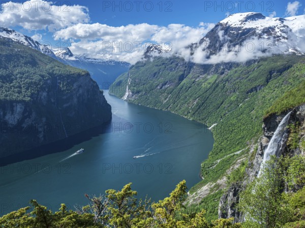 Panorama aerial view of the Geirangerfjord on a sunny spring day, waterfall Gjerdefossen, boats on the sea, Norway, Europe