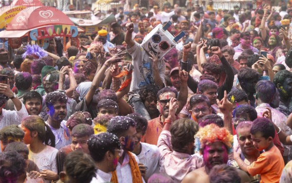 Revellers dancing in the beat of music as they celebrate Holi on a street, the Hindu spring festival of colours on March 25, 2024 in Guwahati, Assam, India. Holi, also known as the Festival of Colors or the Festival of Spring, is one of the most vibrant and joyous festivals in India