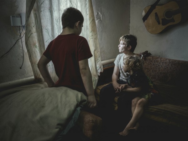 Sasha, 9 years old, Dima, 12 years old and Nastya, 5 years old. They live in the village of Borshchivka, which was occupied by the Russian army for over six months. They suffer from anxiety disorders, the front is only a few kilometres away as the crow flies, Borshchivka, Raion Isyum, Kharkiv Oblast, Ukraine, Europe