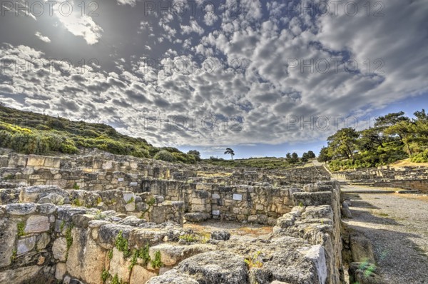 HDR, Ancient ruins with overgrown stone walls under a cloudy sky, historical site, Hellenistic houses, Kamiros, Archaeological site, Ancient city, Foundation of Doric Greeks, Rhodes, Dodecanese, Greek Islands, Greece, Europe
