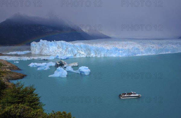 El Calafate, Patagonia, Argentina, Perito Moreno Glacier in Los Glaciares National Park. The Perito Moreno Glacier is part of the Patagonian ice field, the Campo Hielo Sur, the third largest freshwater reserve in the world. It is located in the province of Santa Cruz on Lago Argentino, the country's largest lake. The Perito Moreno Glacier is up to 30 kilometres long and 5 kilometres wide. Its edge is 70 metres high at its highest point. Small icebergs that have broken off from the glacier float in Lago Argentino. The glacier is one of the most beautiful sights in South America and is one of the most visited attractions in Argentina. Tourists can take an excursion boat to the glacier, South America