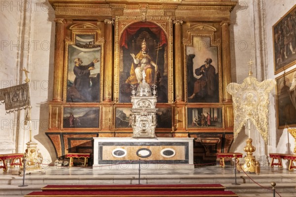 Altar with historical paintings and sacred artworks in a church, Seville