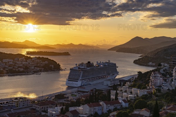 Cruise ship Norwegian Escape in the harbour of Dubrovnik at sunset, Croatia, Europe