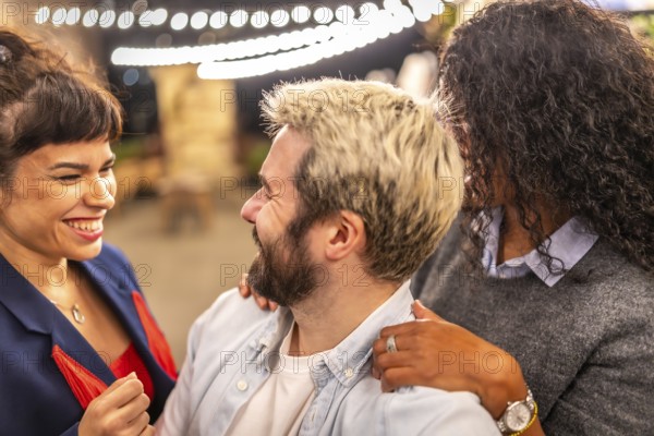 Distracted friends chatting while taking selfies during night party outdoors in the terrace of a bar