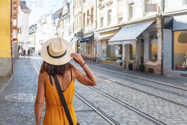 A woman walking through the city of Freiburg im Breisgau, Germany, Europe