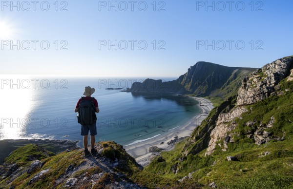 Mountaineer, view of coastal landscape, steep coast with summit Måtind or Måtinden, Høyvika beach and sea, hike to the summit of Måtind, Andøya island, Vesterålen, Nordland, Norway, Europe